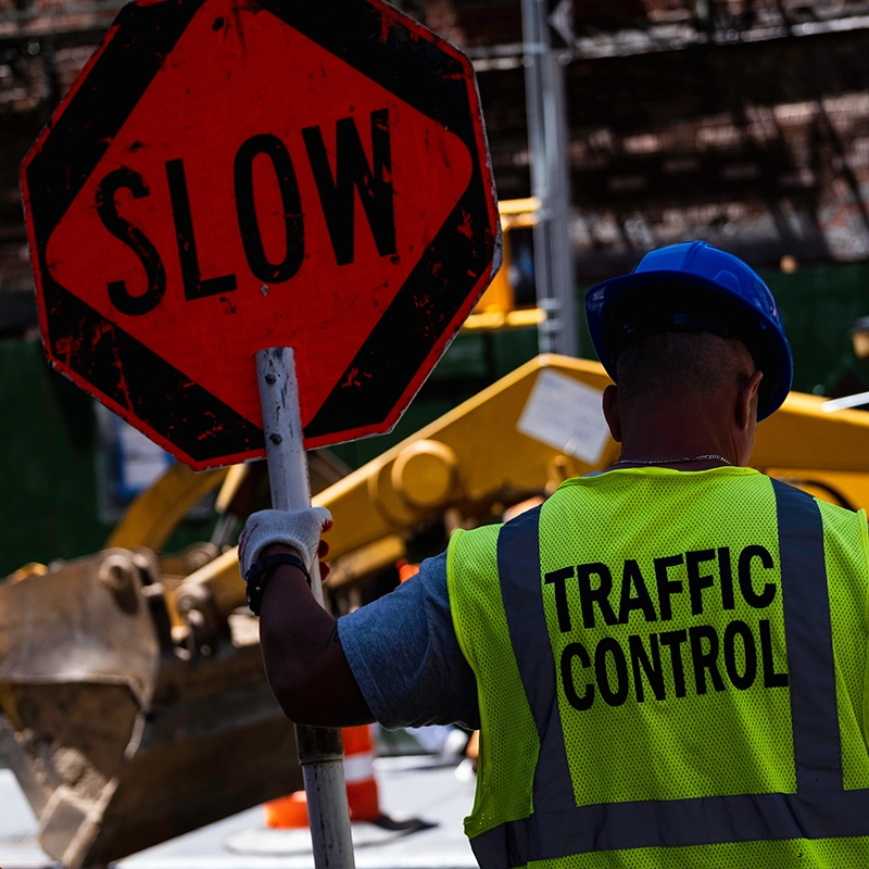 a safety worker holding a slow sign